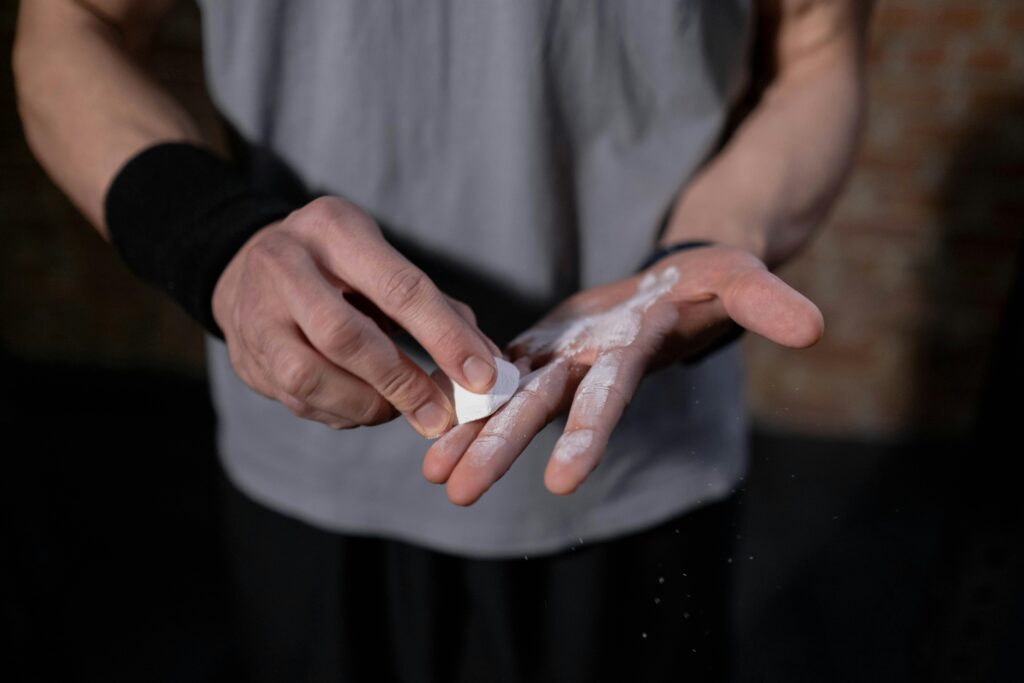 man applying chalk — lifting straps vs chalk comparison