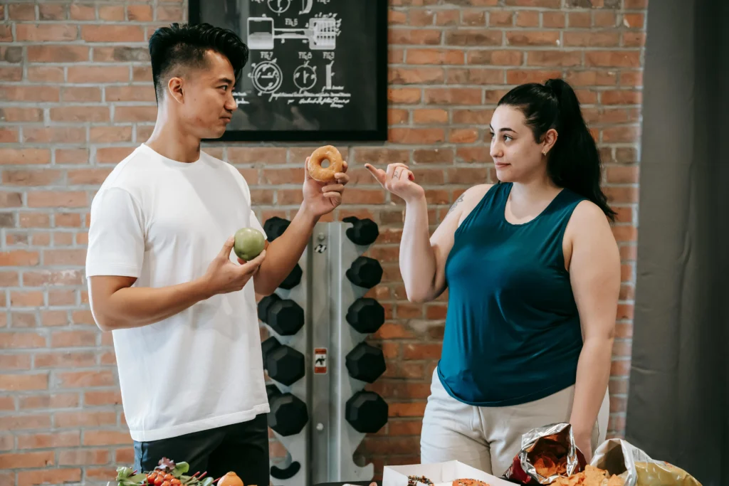 dirty bulk vs clean bulk – healthy food and junk food comparison in a gym setting