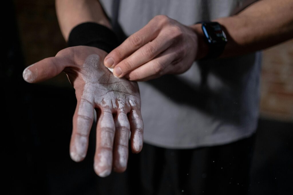 A man applying lifting chalk to his hands before a heavy lift