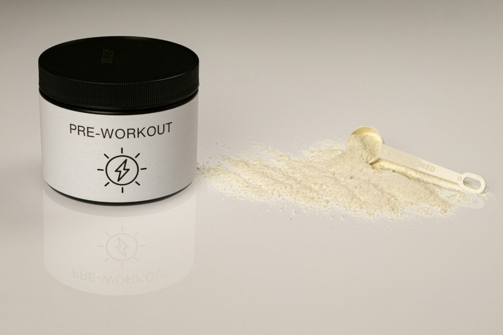Pre-workout powder supplement container with a scoop